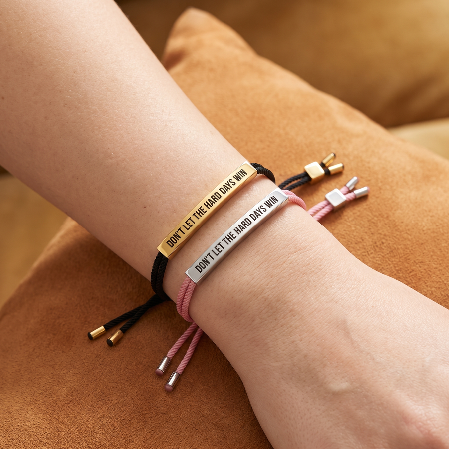 Don't Let The Hard Days Win Bracelet in Black & Gold and Pink & Silver, stacked on the wrist